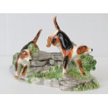 A Booth Derby figure group of two foxhounds, 20cm wide.