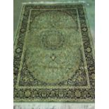 A green ground keshan rug; 190cm x 140cm