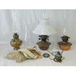 A quantity of oil lamps, shades, chimneys and gauzes.