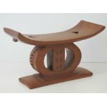 A contemporary carved African hardwood n