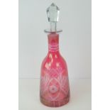 A cranberry glass decanter with stopper,
