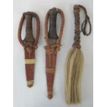 Two hunting knives in leather scabbards a/f, together with a horsehair fly whip. 3 items.