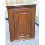 An oak hanging corner cabinet, 106cm hig