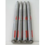 Four inert 40 mm drill rounds on clip, length approx 45 cm.