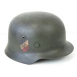 A WWII German helmet, later painted and applied decal, leather lining and chin strap.
