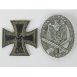 A WWII German Nazi General Assault badge complete with pin, together with an 1813/1939 Iron Cross.