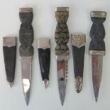 Three Scottish Sgian Dubh knives, complete with scabbards with white metal fittings.