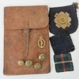 A WWII leather map pouch together with four assorted military brass buttons,