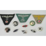A quantity of reproduction WWII cloth and metal badges. 11 in total.