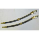 A pair of reproduction Indian cavalry swords, complete with lion head pommel and velvet scabbards,