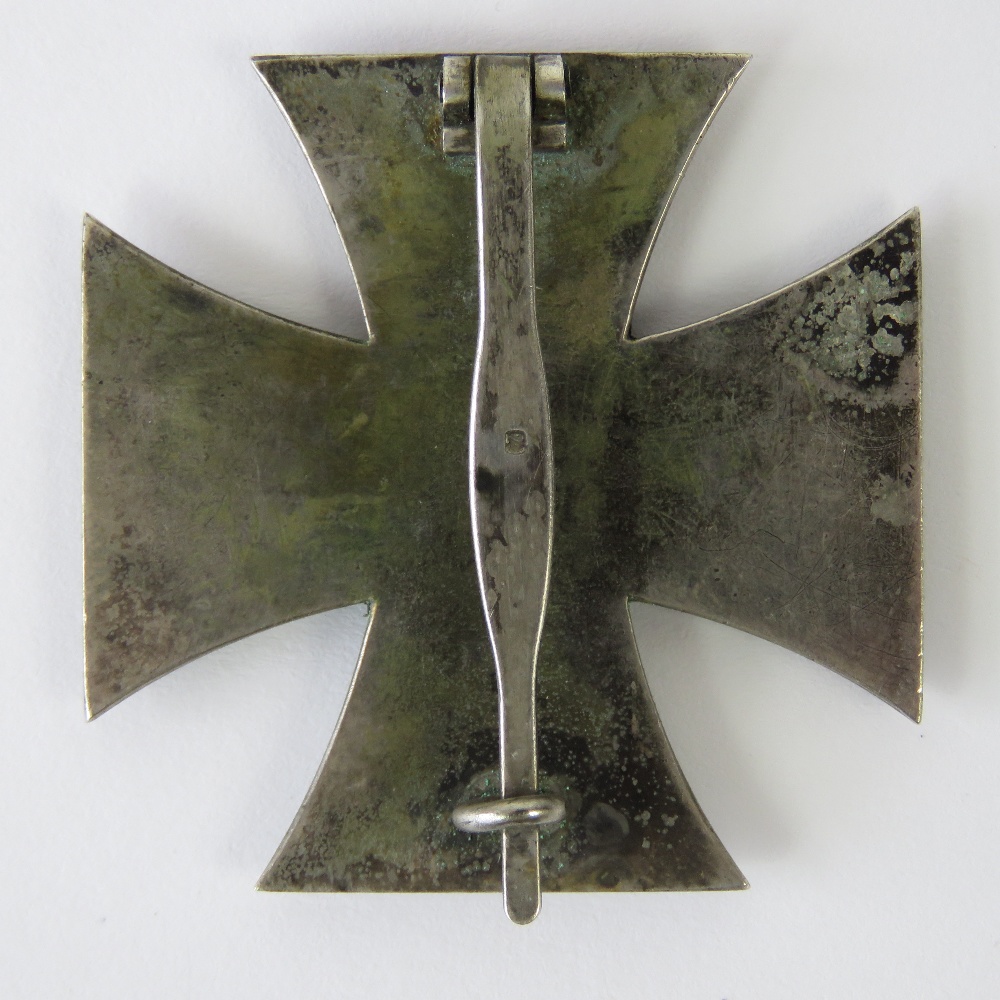 A WWII German Iron Cross 1st Class, pin stamped '20'. - Image 2 of 2