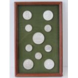 A framed case containing ten Napoleonic plaster seals in positive refief including Ile Sant Helene