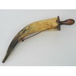 A large late 18th century powder horn having a wooden screw filling cap with opposing brass conical