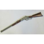 A 20th century copy of a double barrel shotgun, white metal fittings, walnut stock,