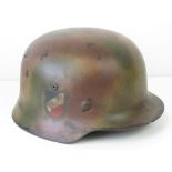 A WWII German helmet, later winter camo