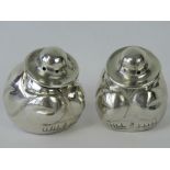 A pair of silver pepperettes in the form of Mexican men, 925 Mexican silver marks to base,