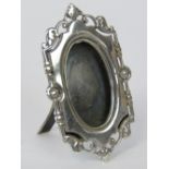 A delightful miniature HM silver photo frame, scrolling vine and rose edge, hallmarked 1983,