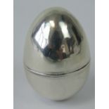A late 18th/early 19th century white metal nutmeg grater in the form of an egg,