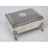 A HM silver jewellery casket of rectangular form raised over four shell legs with lion paw feet,