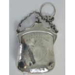 A delightful HM silver purse, complete with carry chain and tan leather interior,