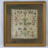 An early 19th century needlework sampler depicting flowers, trees and insects upon,