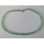 A green jade bead necklace with silver c