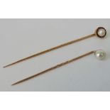 Two rose metal tie or stick pins, one se