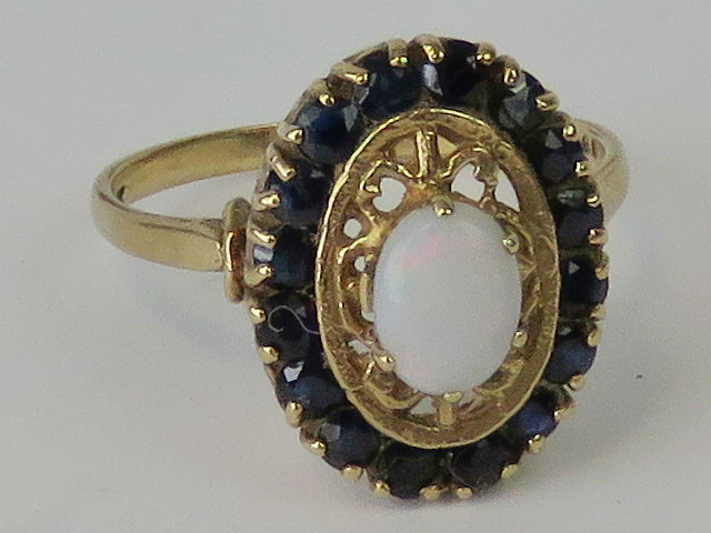 A 9ct gold opal and sapphire ring, centr