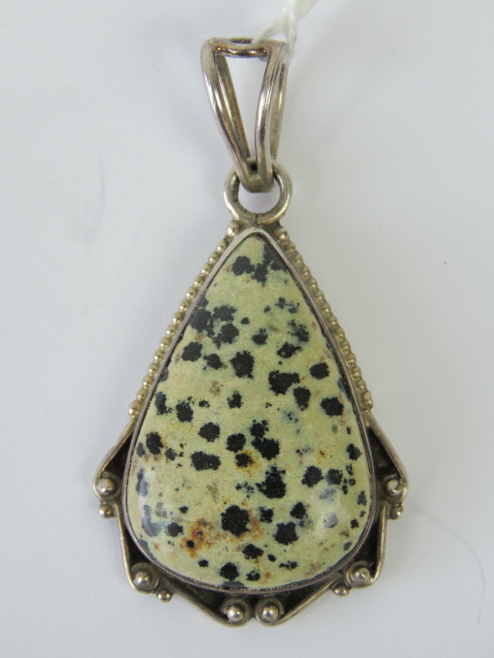 A teardrop shaped dalmatian jasper neckl