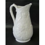 A white earthenware jug, heavily decorat