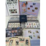 A collection of Royal Mail commemorative mint stamps with presentation cards and two year albums,