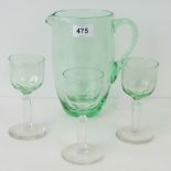 A green glass Pimms jug with three glasses