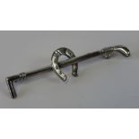 A Stirling silver stock pin or brooch in the form of a riding crop and horse shoe,