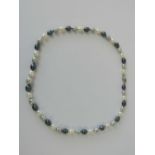 A graduated circle pearl necklace, white, black and grey coloured, with a 925 silver clasp,