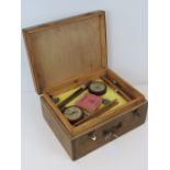 A vintage French wooden fishing tackle box with brass carry handle.