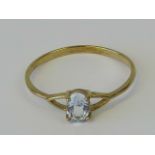 A 9ct gold aquamarine ring, central oval claw set aquamarine, stamped 9ct, size O, 1g.