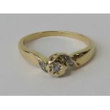 A 9ct gold and diamond ring, raised central panel with diamond in star setting,