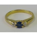 An 18ct gold sapphire and diamond ring, central round cut sapphire of good Ceylon blue hue approx 0.