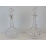 A pair of decanters, with slice cut slender necks and squat spherical bodies,