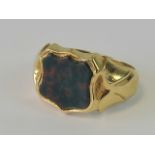 A yellow gold signet ring with inset shield shaped bloodstone seal (unengraved),