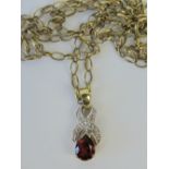 A 9ct gold diamond and red teardrop shaped cz pendant, hallmarked 375 and 2cm long,