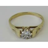 A 9ct gold solitaire ring, illusion set diamond, engraved star pattern to shoulders, hallmarked 375,