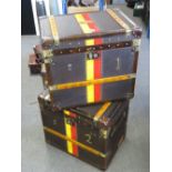 A pair of Army and Navy type brown leather and canvas covered lidded trunks,