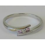 A 9ct white gold diamond and pink sapphire ring,