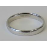 A 9ct white gold band, hallmarked 375, size L-M, 2g.