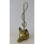A heavy brass door stop fashioned as a fox's head with a riding crop, 41cm high.