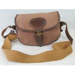 A canvas cartridge bag with leather and canvas strap, approx 25cm wide.