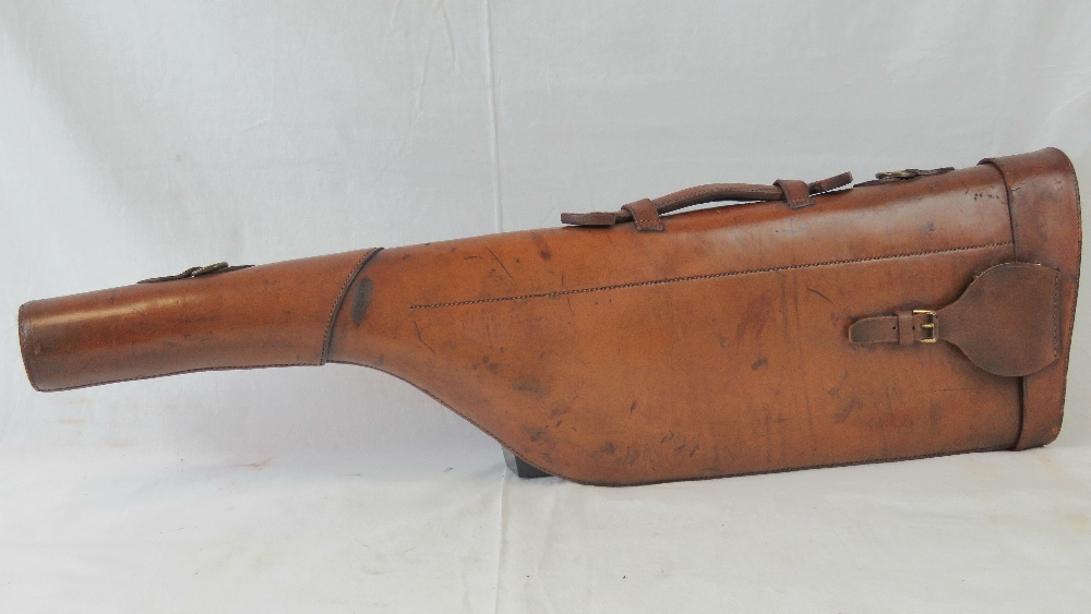 A brown leather leg o'mutton gun case wi