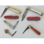 Two Swiss Army pen knives together with