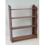 A mahogany four shelf wall hanging rack